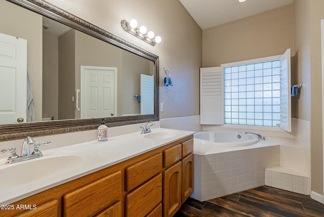 10691 E 37th Pl, Yuma, AZ 85365 - full bath with a bath, wood finished floors, double vanity, and a sink