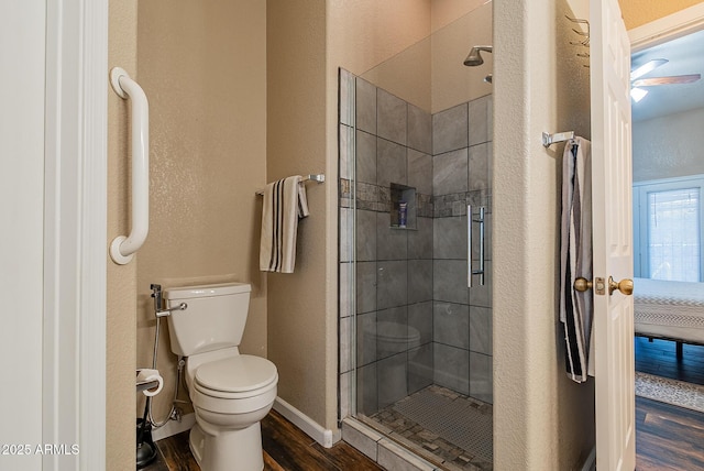 10691 E 37th Pl, Yuma, AZ 85365 - full bathroom with a textured wall, toilet, a stall shower, and wood finished floors