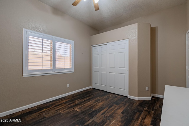 10691 E 37th Pl, Yuma, AZ 85365 - unfurnished bedroom with dark wood-style floors, a closet, baseboards, and a ceiling fan