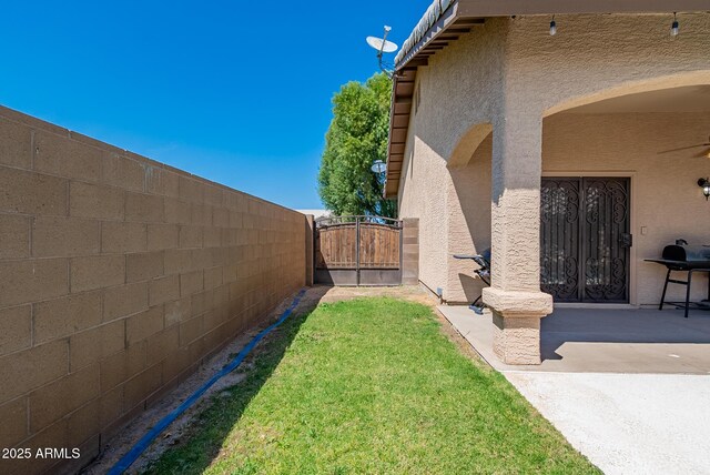 10691 E 37th Pl, Yuma, AZ 85365 - view of yard featuring a patio area, fence, and a gate