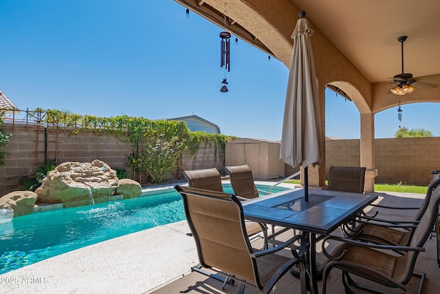 10691 E 37th Pl, Yuma, AZ 85365 - view of patio with a storage shed, a fenced backyard, outdoor dining space, and an outbuilding