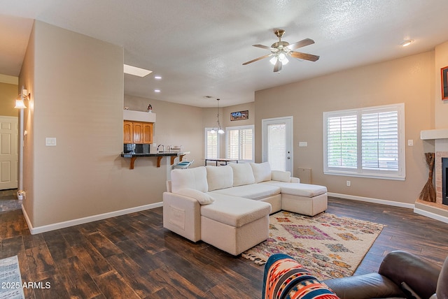 10691 E 37th Pl, Yuma, AZ 85365 - living room with plenty of natural light, dark wood-style floors, baseboards, and a ceiling fan
