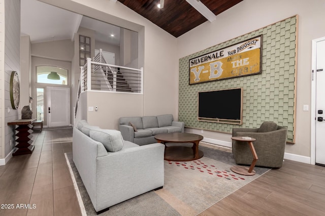 living room featuring hardwood / wood-style floors, beamed ceiling, high vaulted ceiling, and wooden ceiling