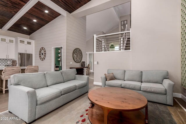 living room with high vaulted ceiling, hardwood / wood-style flooring, wooden ceiling, and beamed ceiling