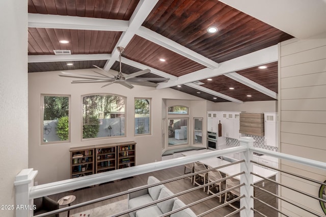 interior space with vaulted ceiling with beams, wood ceiling, and ceiling fan