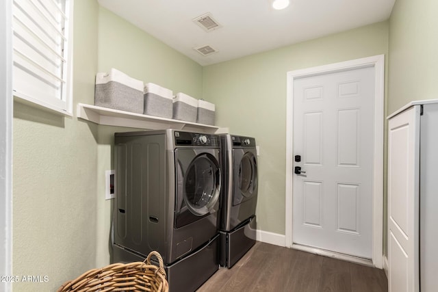 laundry room featuring separate washer and dryer and dark hardwood / wood-style floors