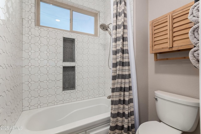 bathroom featuring shower / bath combo with shower curtain and toilet