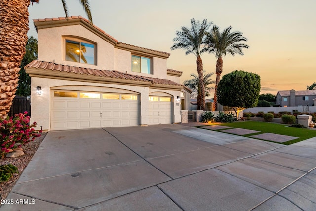 mediterranean / spanish home with a garage