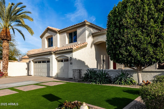 mediterranean / spanish house with a garage and a front lawn