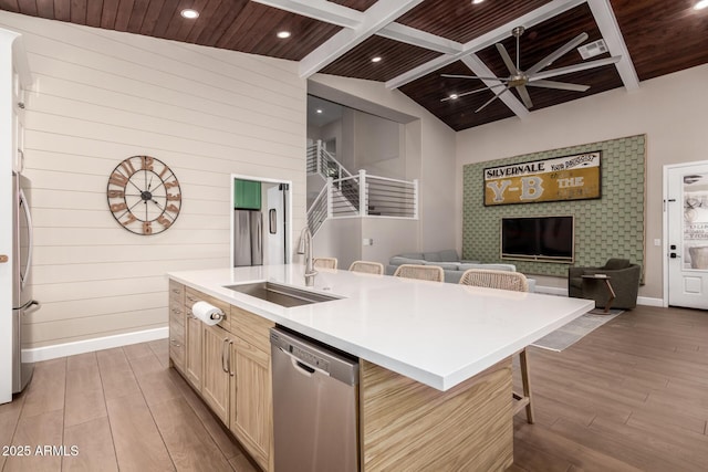 kitchen with sink, light hardwood / wood-style flooring, a breakfast bar, a kitchen island with sink, and stainless steel appliances