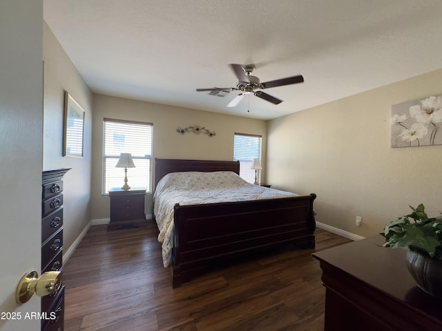 bedroom with a ceiling fan, baseboards, and dark wood finished floors