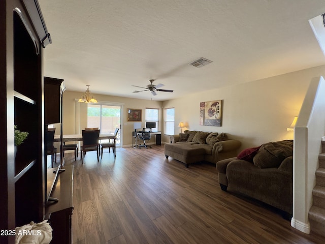 living area with dark wood finished floors, baseboards, a ceiling fan, and visible vents