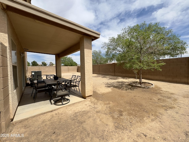 view of patio with a fenced backyard and outdoor dining space