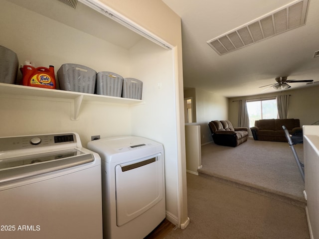 laundry area featuring washing machine and clothes dryer, ceiling fan, visible vents, baseboards, and laundry area