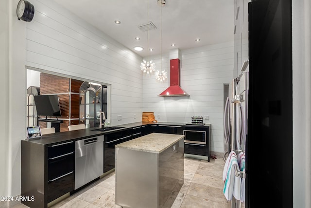 kitchen with a center island, sink, exhaust hood, stainless steel dishwasher, and decorative light fixtures