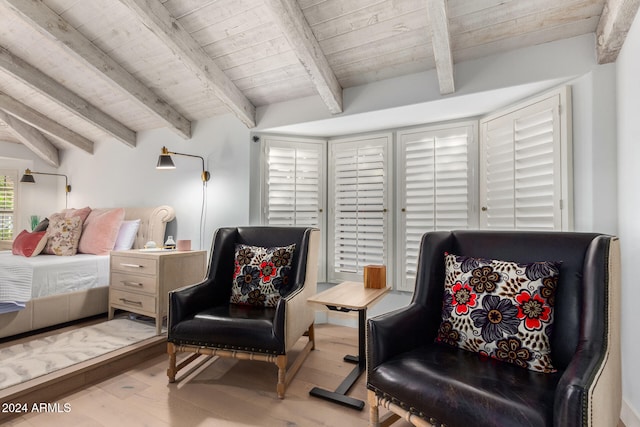 living area with hardwood / wood-style floors, beamed ceiling, and wooden ceiling