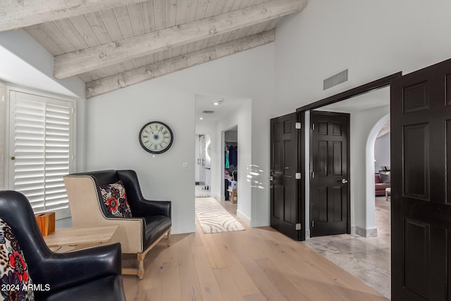 sitting room featuring wooden ceiling, light hardwood / wood-style flooring, and lofted ceiling with beams