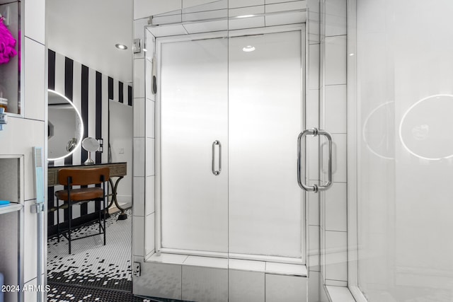 bathroom featuring tile patterned floors and a shower with door