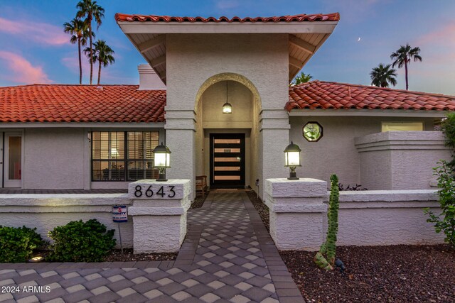 view of exterior entry at dusk