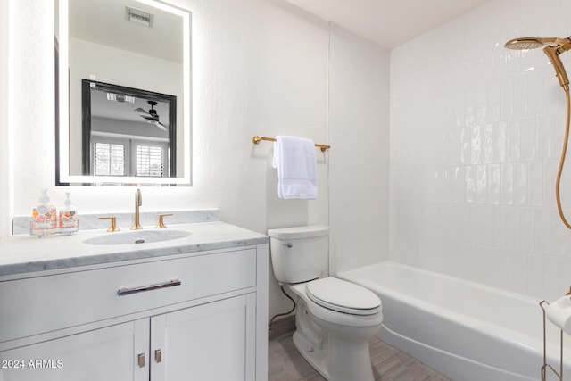 full bathroom with vanity, toilet, and tiled shower / bath combo