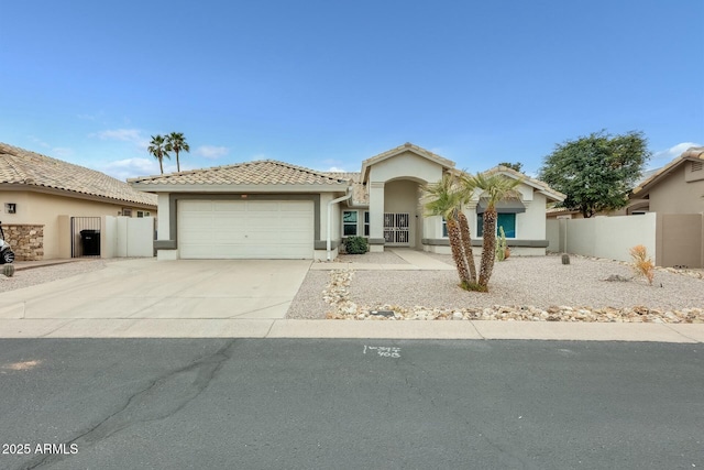 17514 N Rainbow Cir, Surprise, AZ 85374 - view of front of house featuring stucco siding, driveway, a garage, and fence
