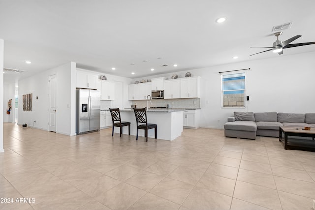 tiled living room with ceiling fan