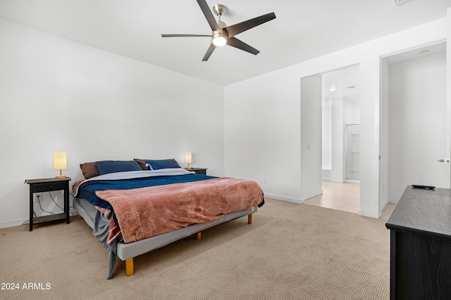 carpeted bedroom featuring ceiling fan and ensuite bath