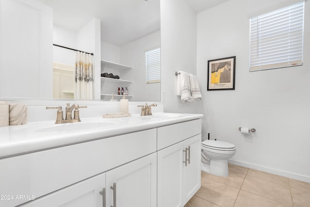 bathroom featuring vanity, toilet, tile patterned floors, and walk in shower