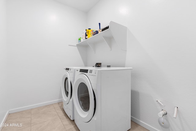 washroom with light tile patterned flooring and washing machine and clothes dryer