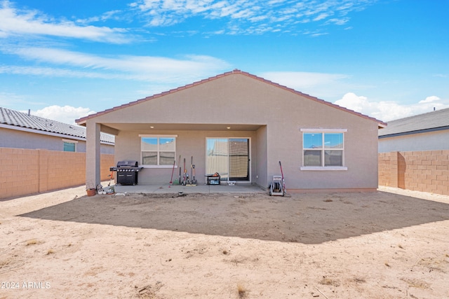 back of property with a patio