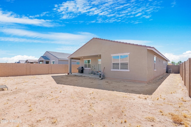 rear view of property featuring a patio