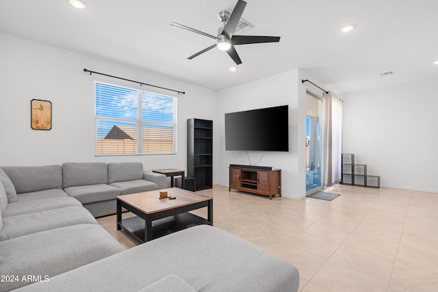 tiled living room featuring ceiling fan