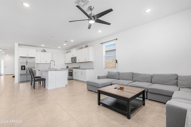 tiled living room featuring sink and ceiling fan