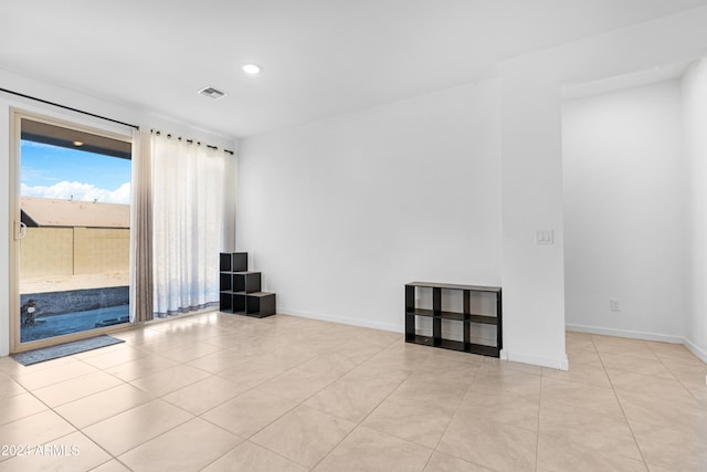 unfurnished room featuring light tile patterned floors