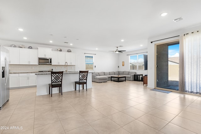 living room with light tile patterned flooring and ceiling fan