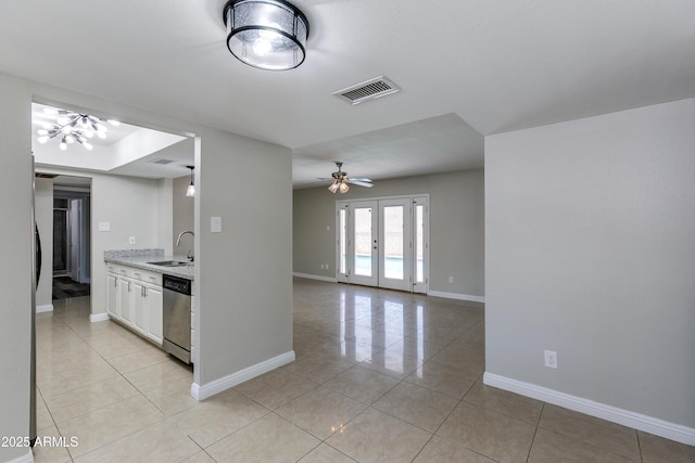 kitchen with french doors, sink, white cabinetry, light stone counters, and stainless steel dishwasher