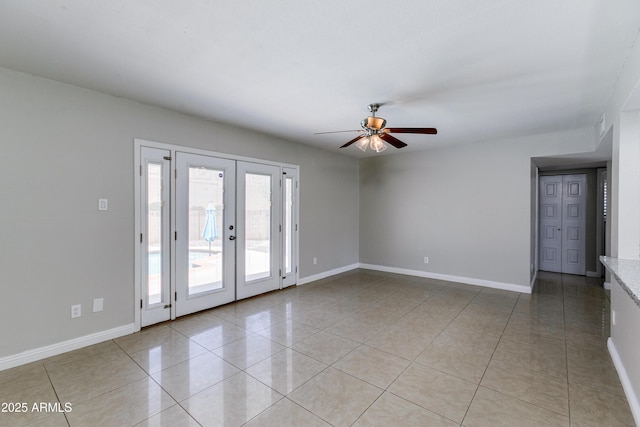 tiled empty room with ceiling fan and french doors