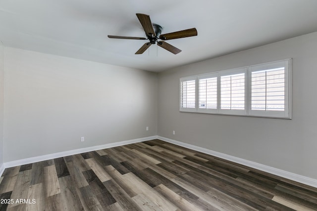 spare room featuring dark hardwood / wood-style floors and ceiling fan