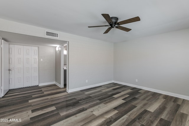 unfurnished bedroom with ceiling fan, dark hardwood / wood-style flooring, and a closet