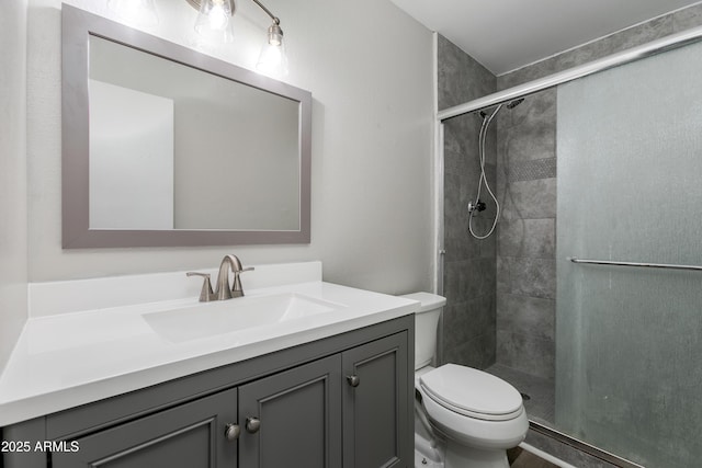 bathroom with vanity, walk in shower, and toilet