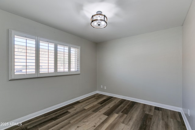 unfurnished room featuring dark hardwood / wood-style flooring