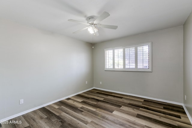 empty room with hardwood / wood-style flooring and ceiling fan