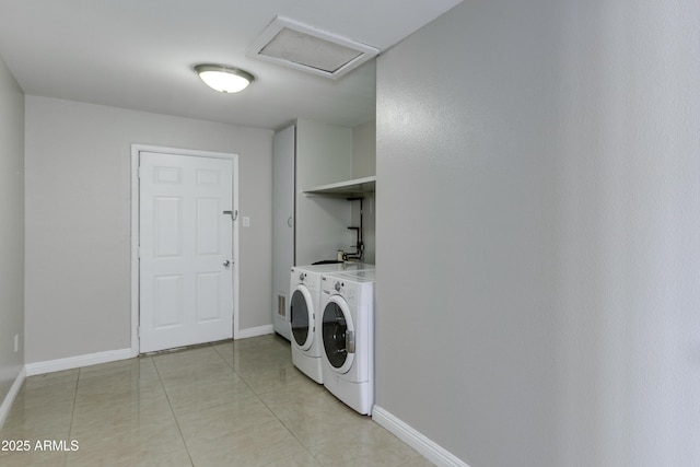 clothes washing area featuring separate washer and dryer and light tile patterned floors