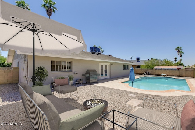 view of pool with french doors, cooling unit, grilling area, an outdoor living space, and a patio area