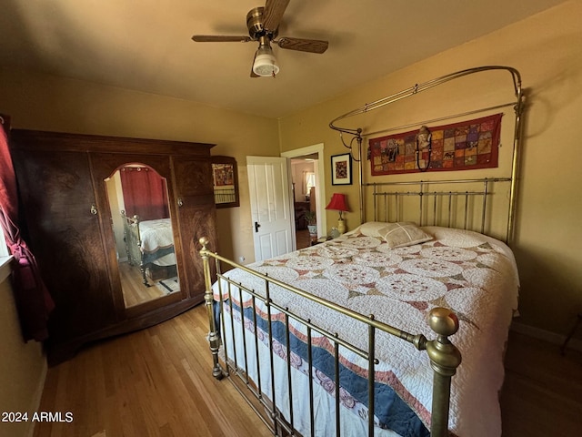 bedroom featuring hardwood / wood-style flooring and ceiling fan