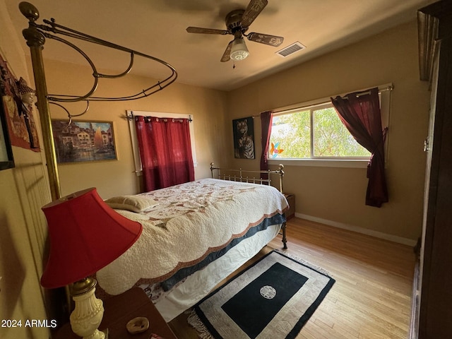 bedroom with ceiling fan and light hardwood / wood-style flooring
