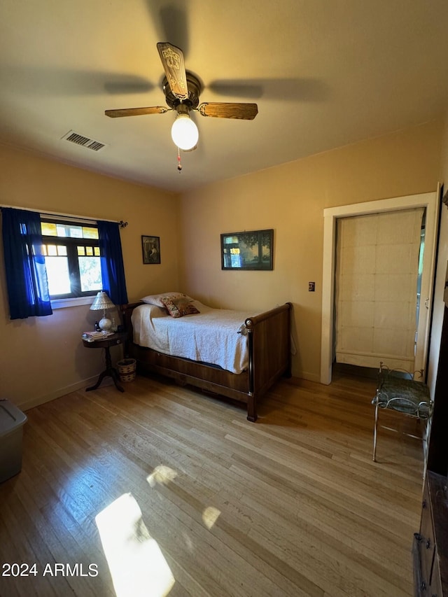unfurnished bedroom featuring hardwood / wood-style floors and ceiling fan
