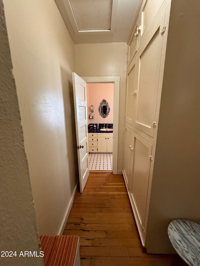 hallway featuring dark hardwood / wood-style floors and sink