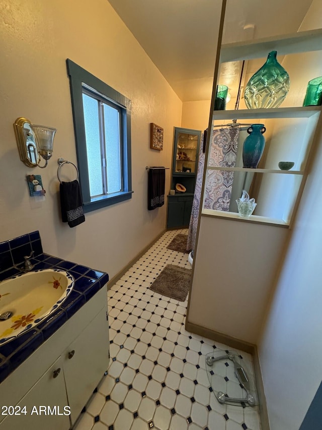 bathroom with vanity and vaulted ceiling