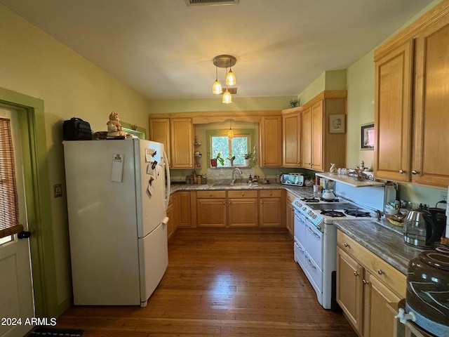 kitchen featuring pendant lighting, sink, white appliances, dark hardwood / wood-style flooring, and light brown cabinetry